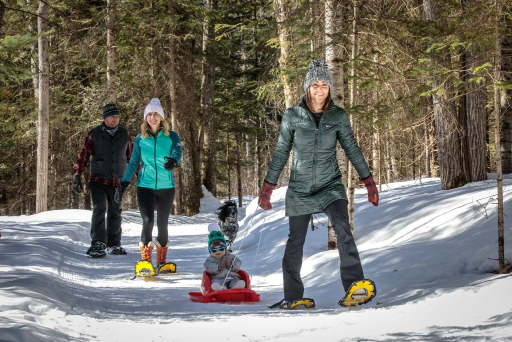 Group enjoying the snowshoe trails at WinMan with their dog and small child