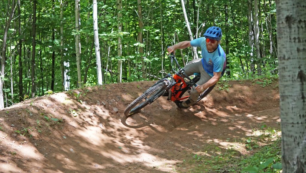Professional trail builder Joel attaching a berm (he built) at WinMan 