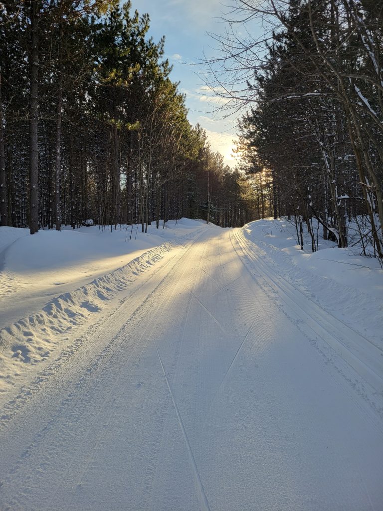 Ski trail at sunrise and freshly groomed