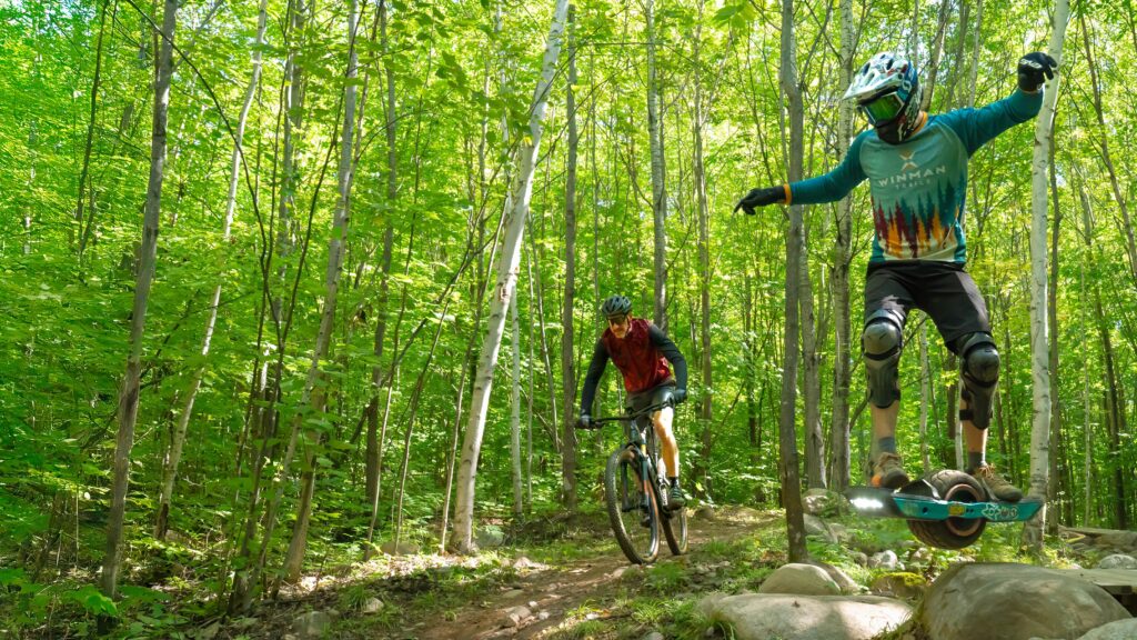 mountain biker and onehwheeler sharing the same trail together