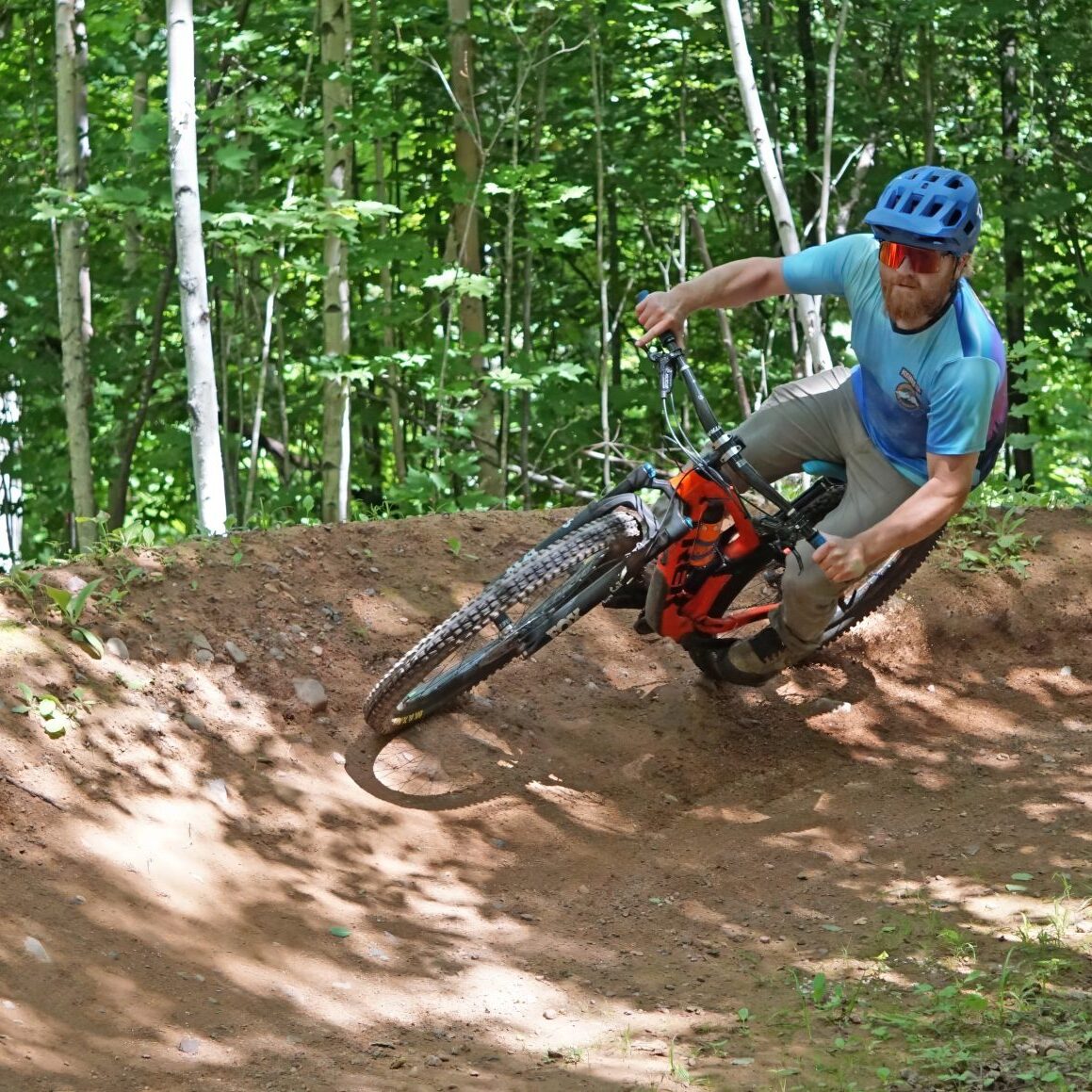Professional trail builder Joel attaching a berm (he built) at WinMan 
